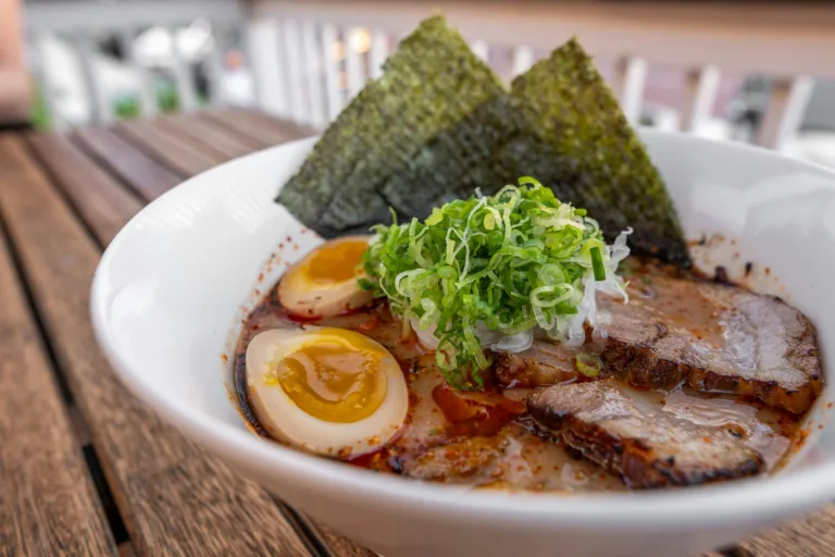 A scrumptious bowl of ramen with soy sauce eggs, chashu, and seaweed, perfect for dining.