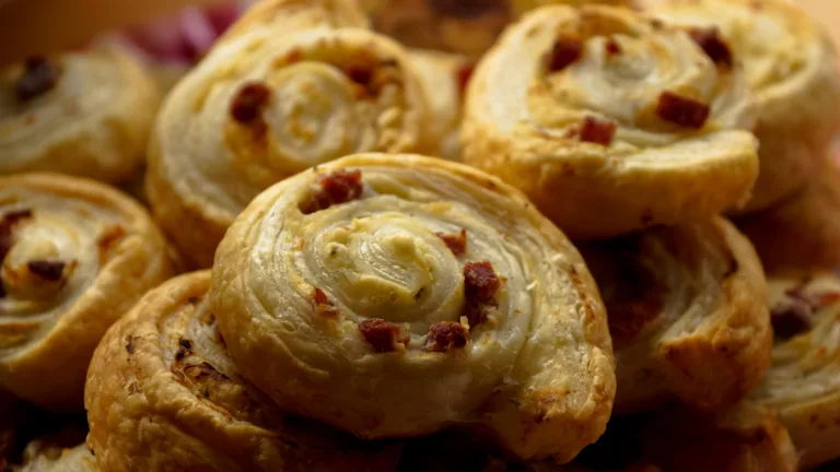 Savor the taste of homemade puff pastry rolls with bacon and cheese.